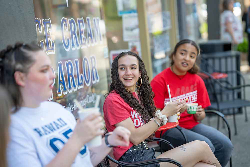 Western Oregon University students sitting together outside at local ice cream parlor